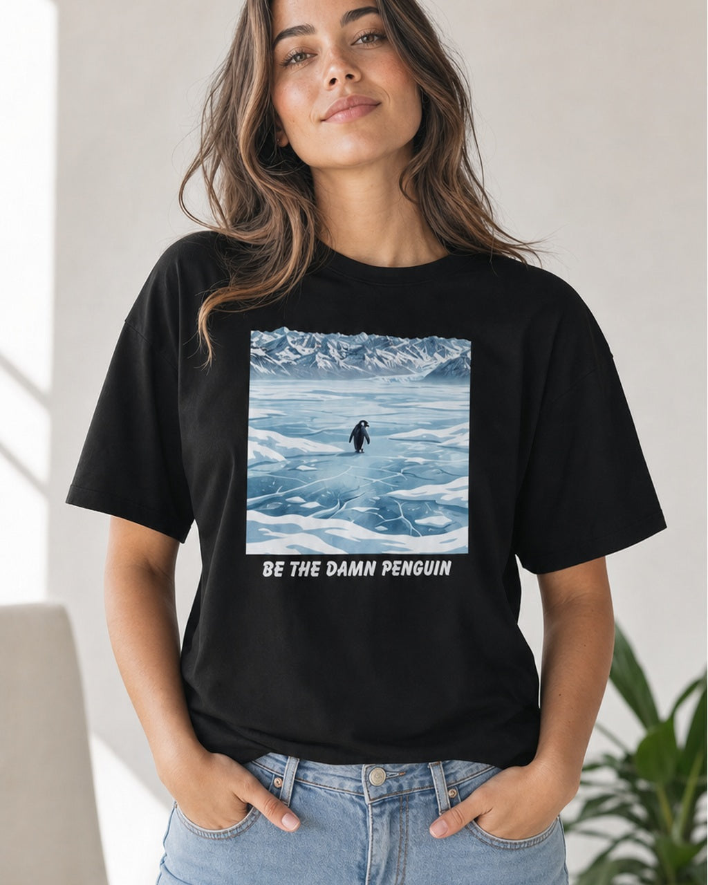 Be the Damn Penguin black graphic tee shown on a model in a studio