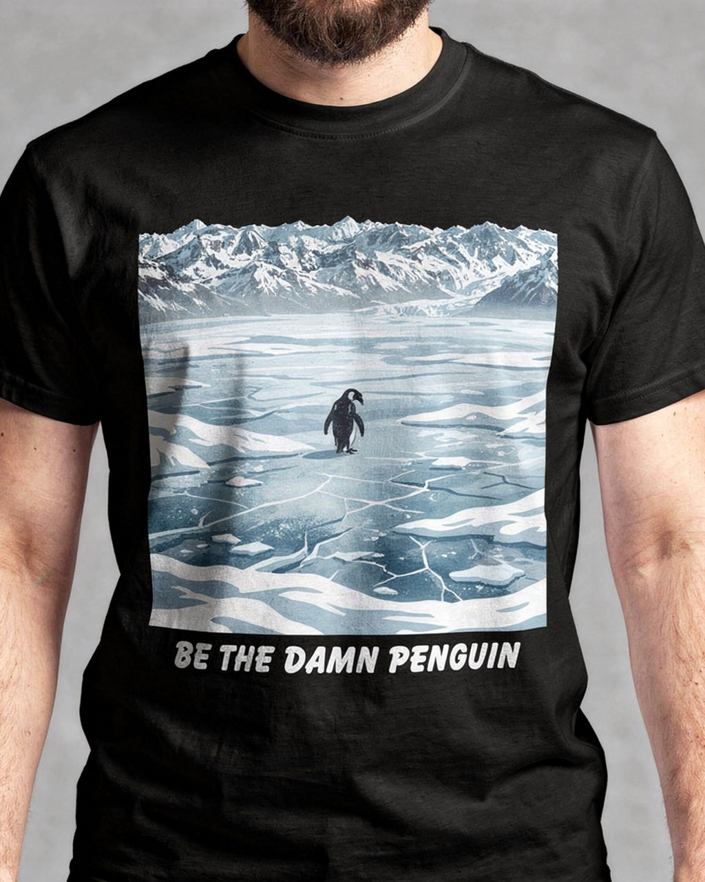 Torso view of the Be the Damn Penguin graphic on a black tee