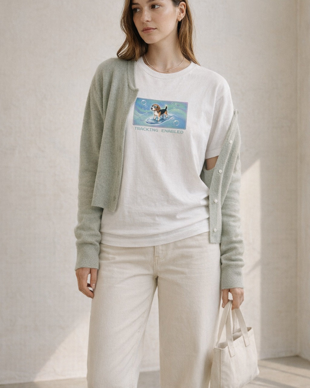 O's Tees Tracking Enabled Beagle Frutiger Aero Dogs graphic tee lifestyle image — White shirt, female shot 02, sage cardigan cream denim