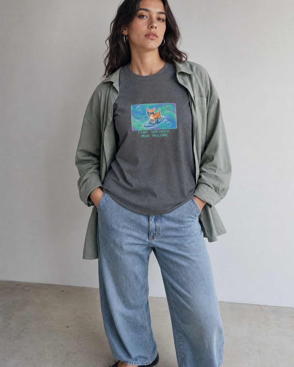 O's Tees Tiny Speaker, Max Volume Chihuahua Frutiger Aero Dogs graphic tee lifestyle image — Graphite Heather shirt, female shot 01, washed blue denim sage