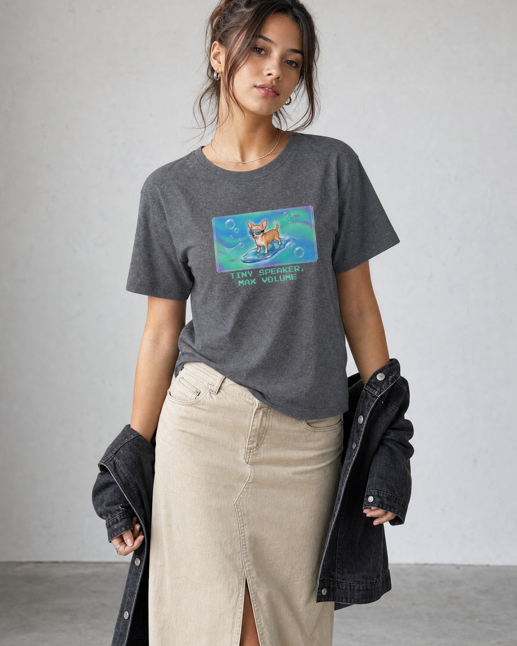 O's Tees Tiny Speaker, Max Volume Chihuahua Frutiger Aero Dogs graphic tee lifestyle image — Graphite Heather shirt, female shot 02, stone column skirt black jacket