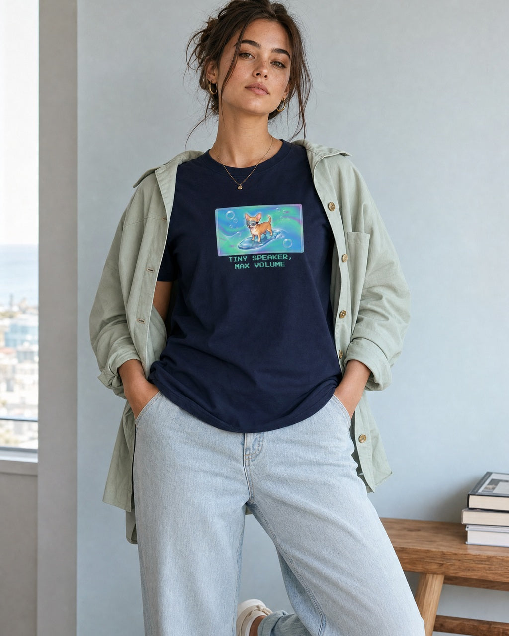 O's Tees Tiny Speaker, Max Volume Chihuahua Frutiger Aero Dogs graphic tee lifestyle image — Navy shirt, female shot 02, lightwash sage