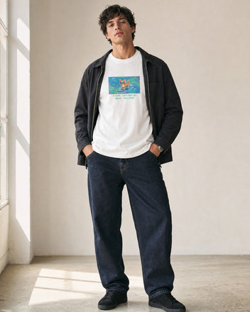 O's Tees Tiny Speaker, Max Volume Chihuahua Frutiger Aero Dogs graphic tee lifestyle image — White shirt, male shot 02, indigo workwear