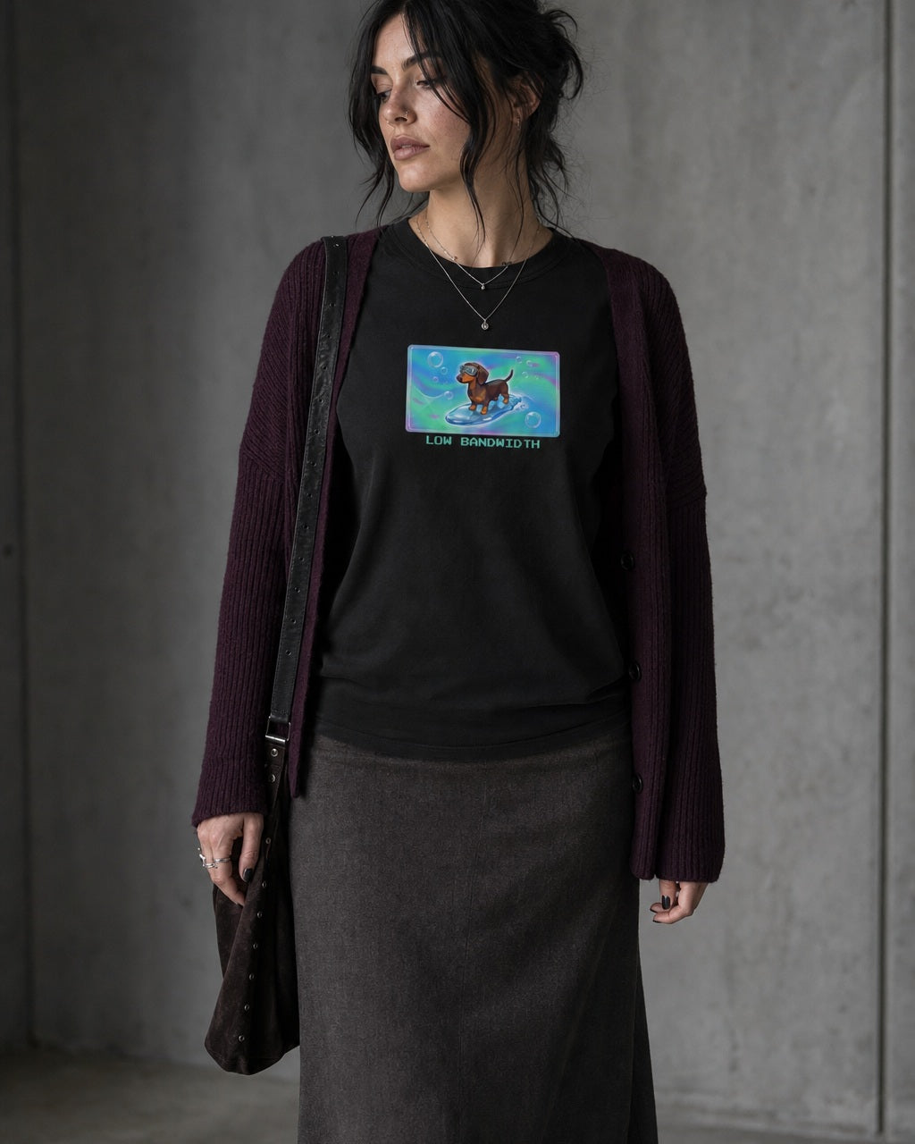 O's Tees Low Bandwidth Dachshund Frutiger Aero Dogs graphic tee lifestyle image — Black shirt, female shot 02, charcoal maxi plum