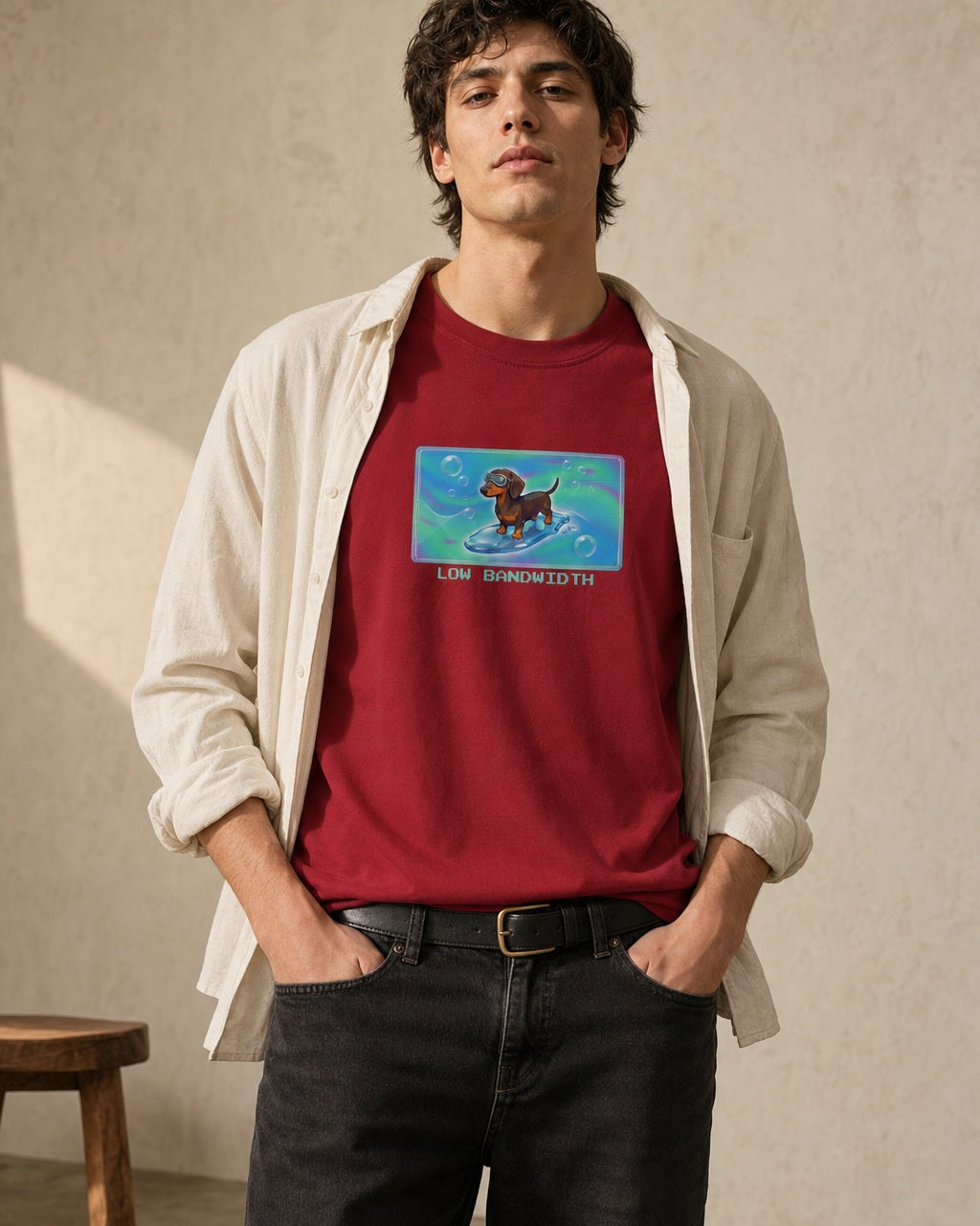 O's Tees Low Bandwidth Dachshund Frutiger Aero Dogs graphic tee lifestyle image — Cardinal Red shirt, male shot 02, black jeans cream overshirt