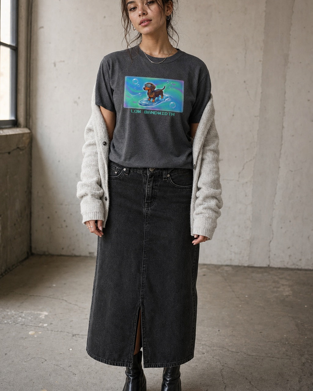 O's Tees Low Bandwidth Dachshund Frutiger Aero Dogs graphic tee lifestyle image — Dark Heather shirt, female shot 02, washed black column skirt