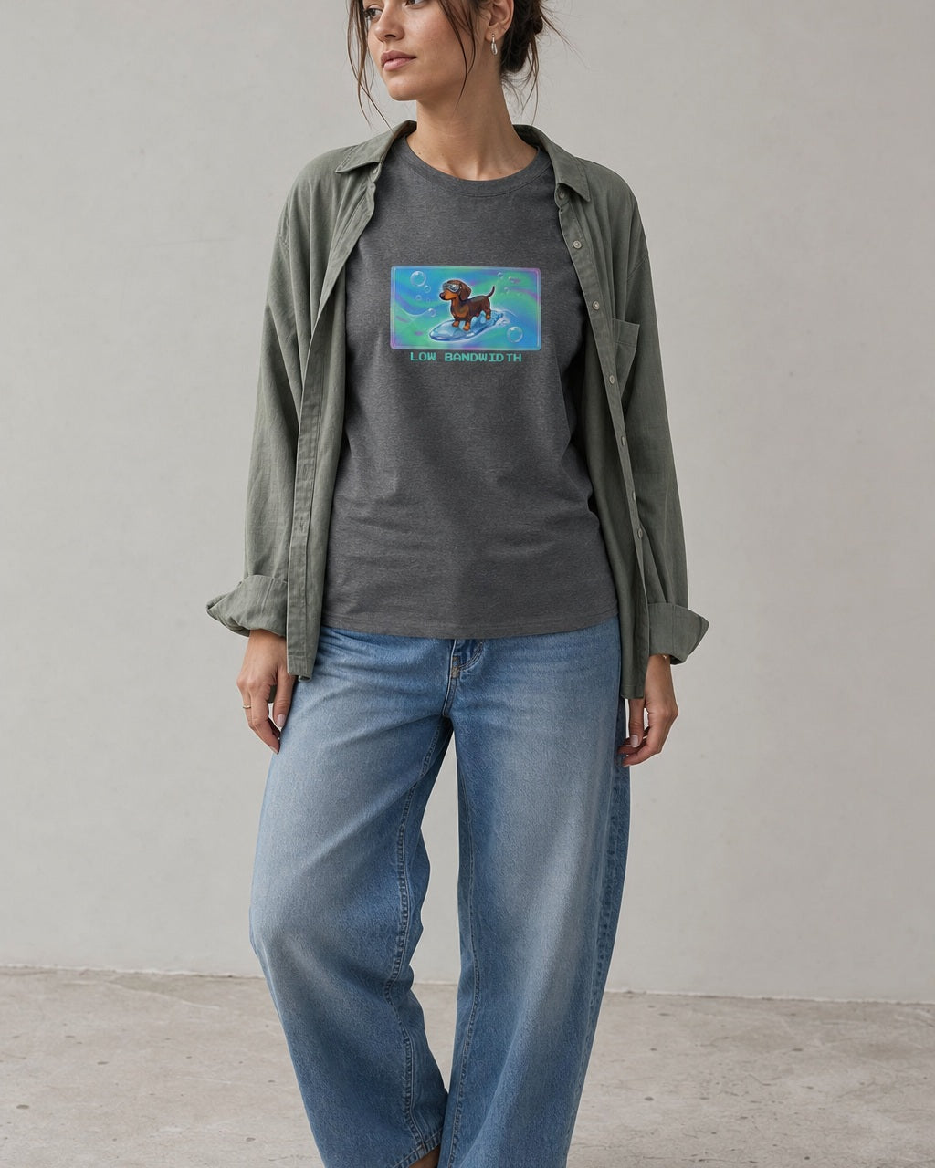 O's Tees Low Bandwidth Dachshund Frutiger Aero Dogs graphic tee lifestyle image — Graphite Heather shirt, female shot 01, washed blue denim sage