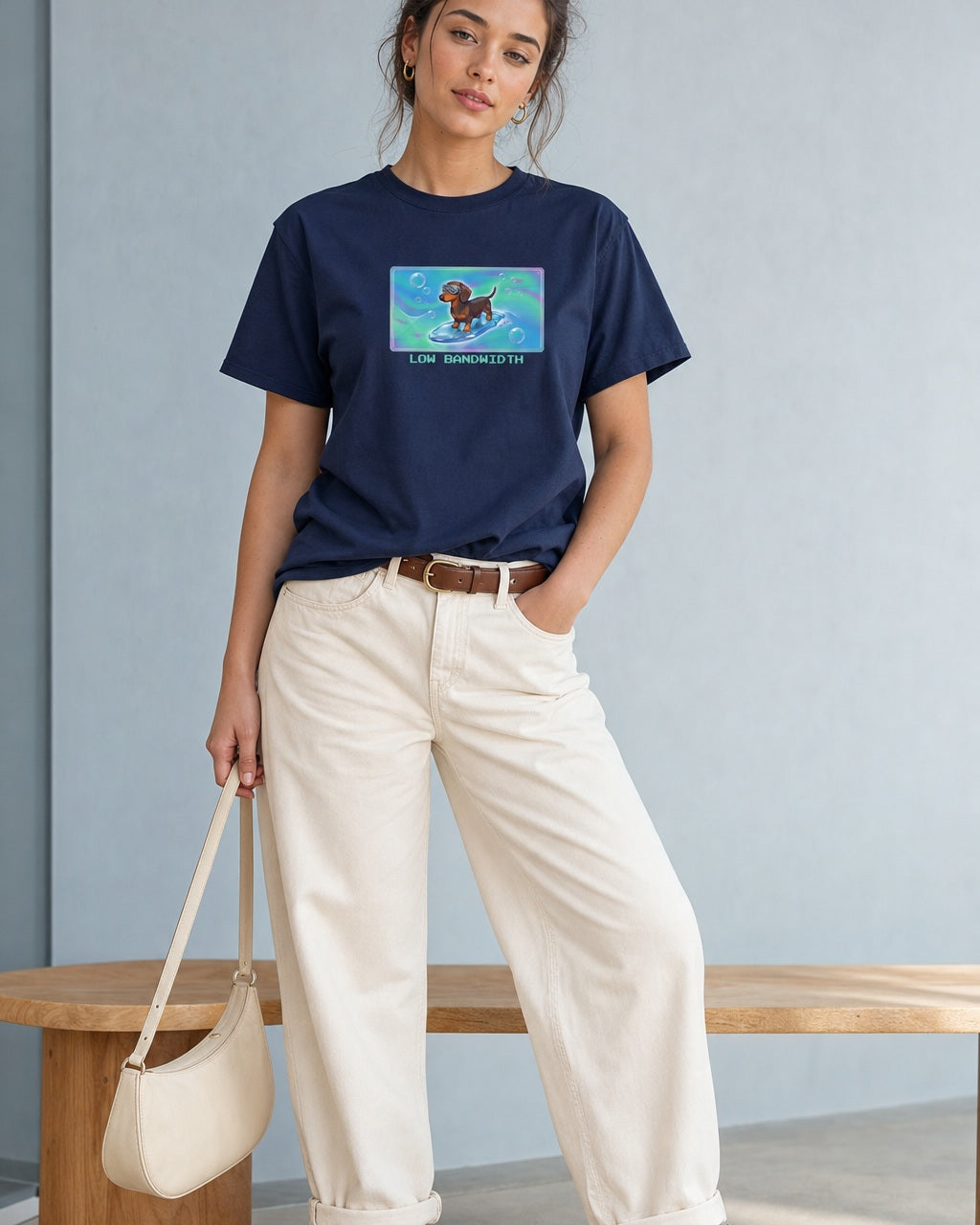 O's Tees Low Bandwidth Dachshund Frutiger Aero Dogs graphic tee lifestyle image — Navy shirt, female shot 01, ecru barrel tan suede