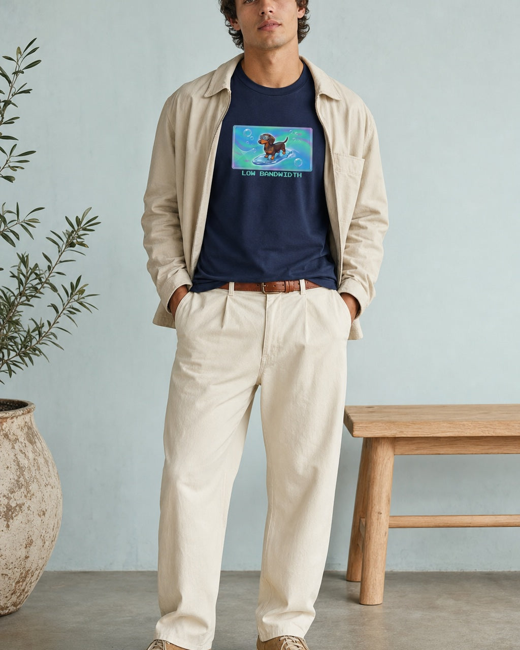 O's Tees Low Bandwidth Dachshund Frutiger Aero Dogs graphic tee lifestyle image — Navy shirt, male shot 01, ecru trouser field