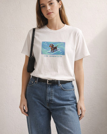 O's Tees Low Bandwidth Dachshund Frutiger Aero Dogs graphic tee lifestyle image — White shirt, female shot 01, barrel denim mary jane