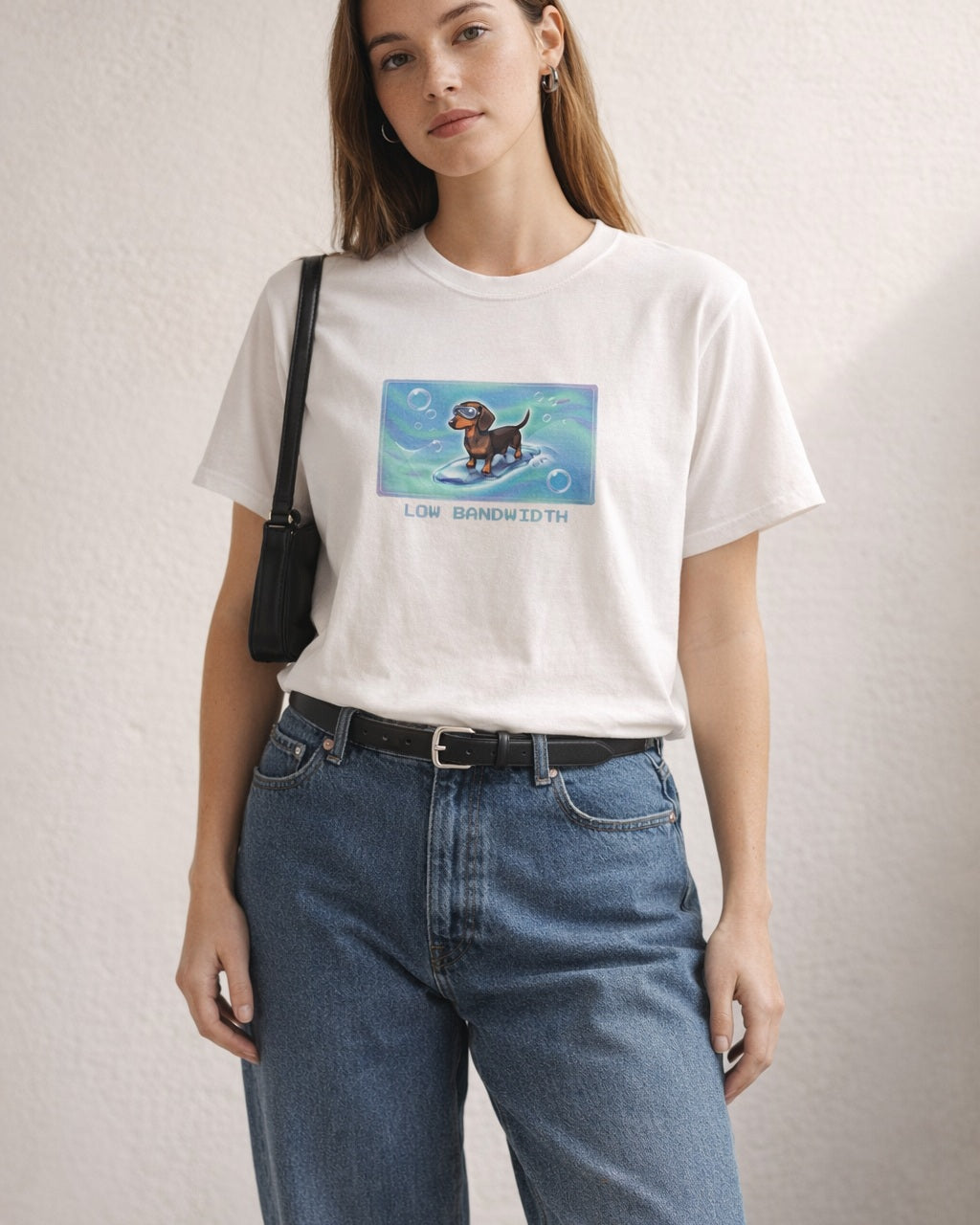 O's Tees Low Bandwidth Dachshund Frutiger Aero Dogs graphic tee lifestyle image — White shirt, female shot 01, barrel denim mary jane