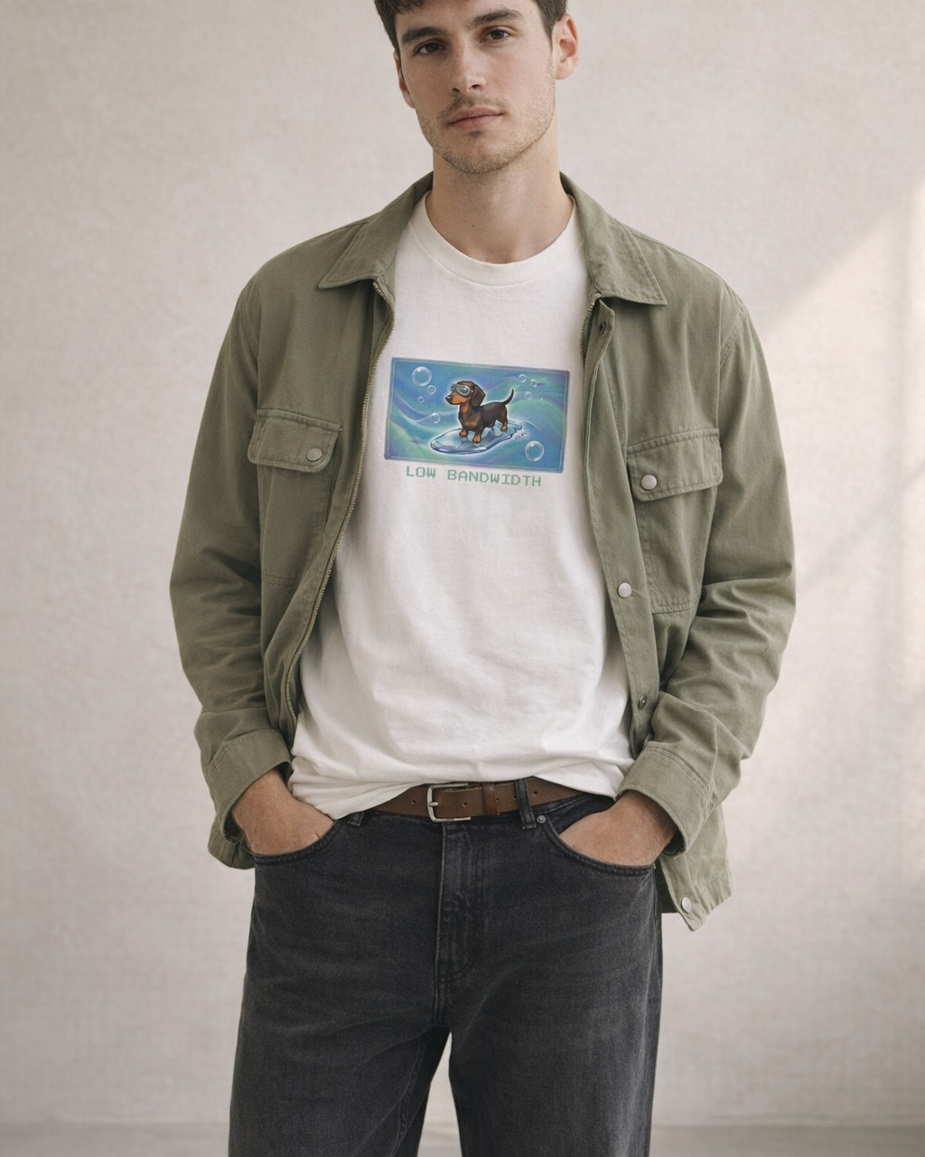 O's Tees Low Bandwidth Dachshund Frutiger Aero Dogs graphic tee lifestyle image — White shirt, male shot 01, black denim field jacket