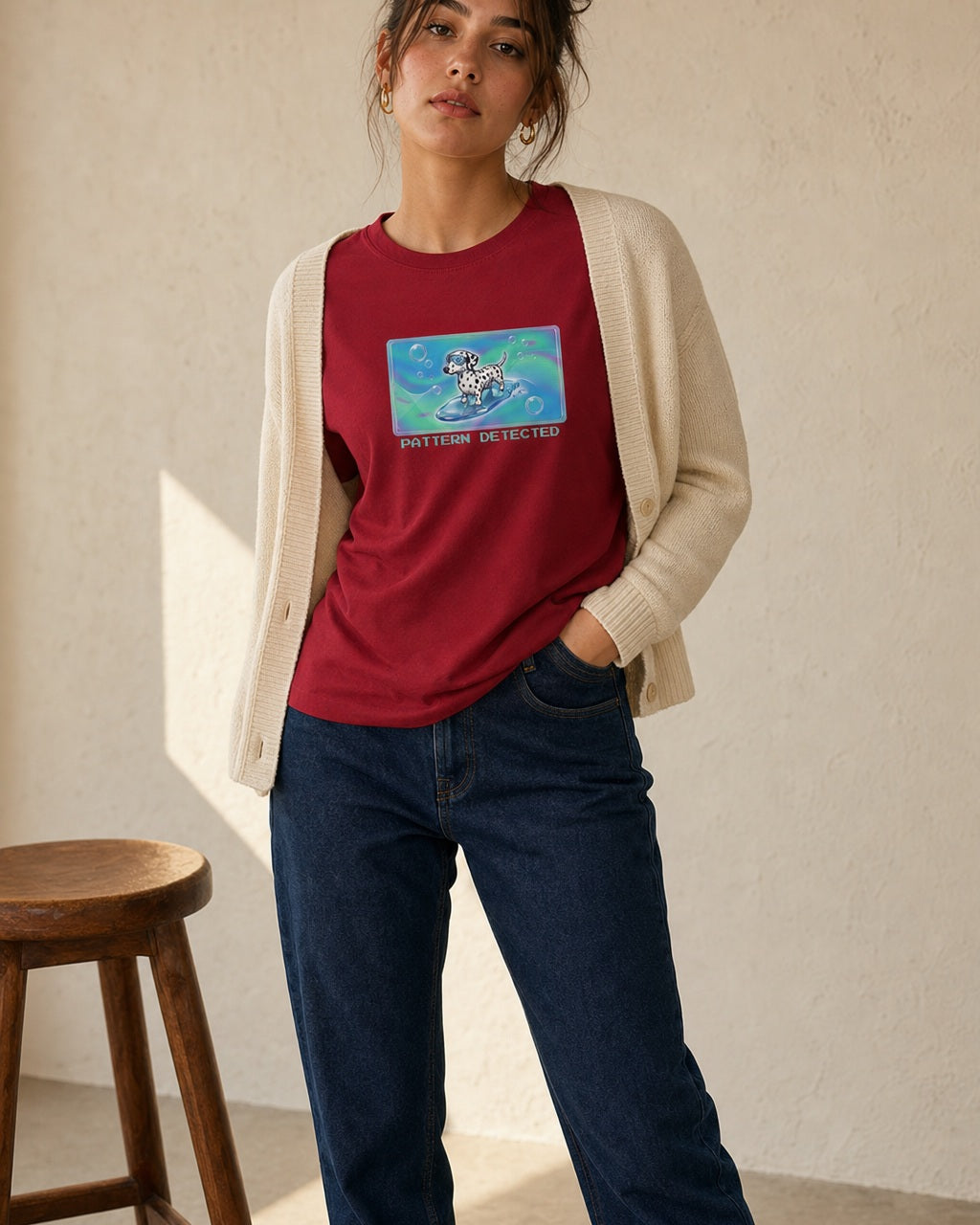 O's Tees Pattern Detected Dalmatian Frutiger Aero Dogs graphic tee lifestyle image — Cardinal Red shirt, female shot 01, dark indigo cream cardigan