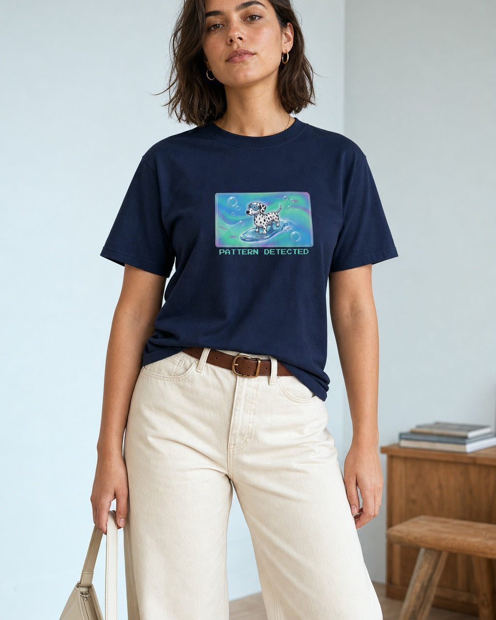O's Tees Pattern Detected Dalmatian Frutiger Aero Dogs graphic tee lifestyle image — Navy shirt, female shot 01, ecru barrel tan suede