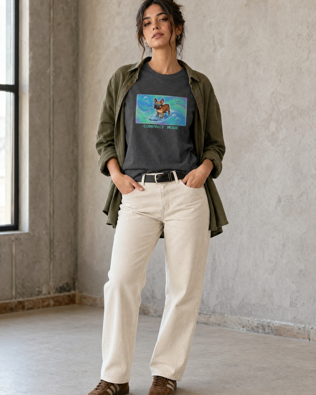 O's Tees Compact Mode French Bulldog Frutiger Aero Dogs graphic tee lifestyle image — Dark Heather shirt, female shot 01, ecru denim olive overshirt