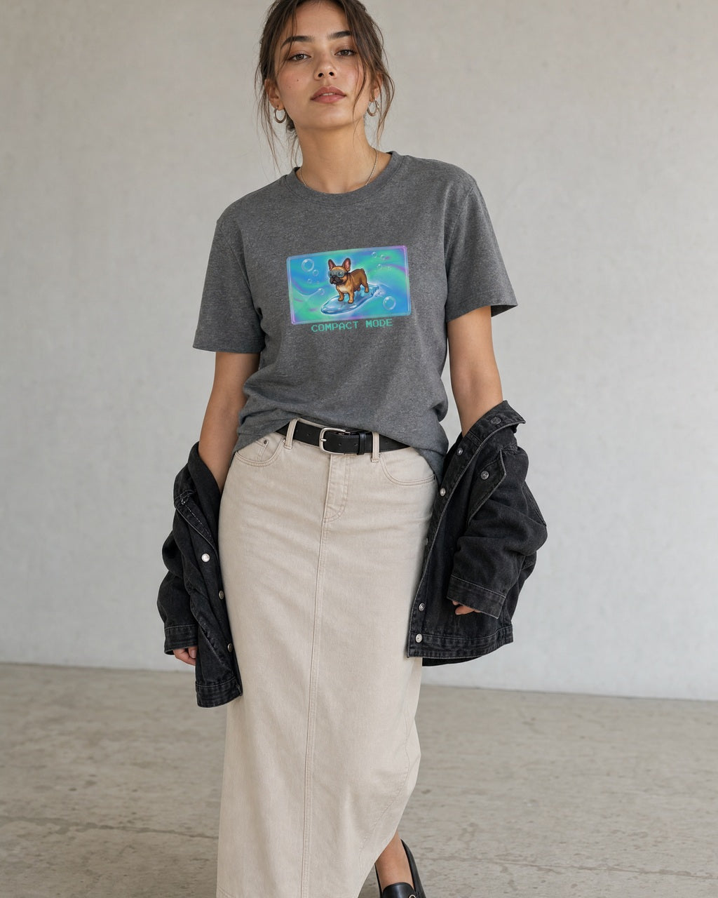 O's Tees Compact Mode French Bulldog Frutiger Aero Dogs graphic tee lifestyle image — Graphite Heather shirt, female shot 02, stone column skirt black jacket