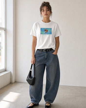 O's Tees Compact Mode French Bulldog Frutiger Aero Dogs graphic tee lifestyle image — White shirt, female shot 01, barrel denim mary jane