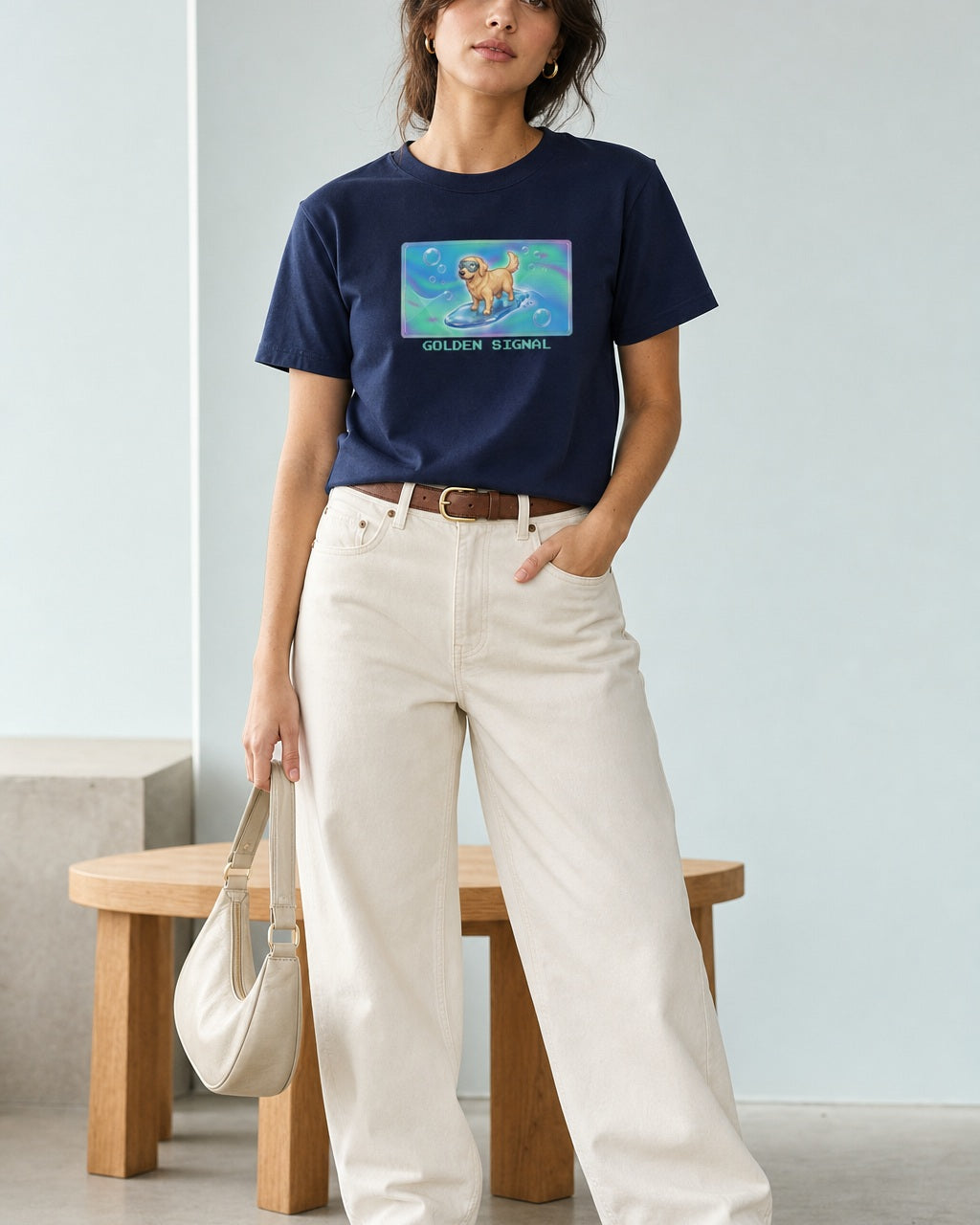 O's Tees Golden Signal Golden Retriever Frutiger Aero Dogs graphic tee lifestyle image — Navy shirt, female shot 01, ecru barrel tan suede