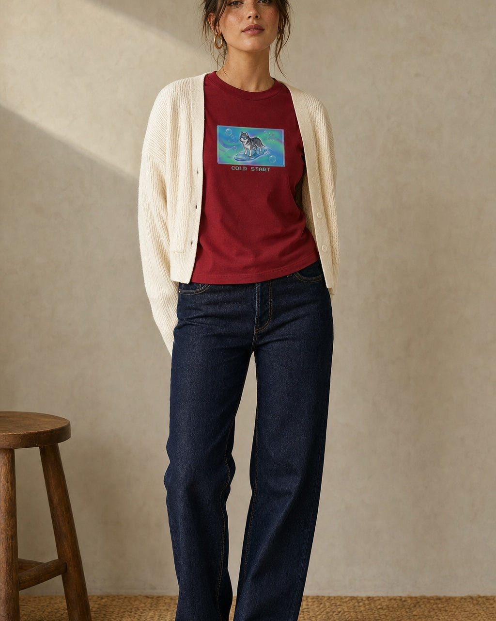 O's Tees Cold Start Husky Frutiger Aero Dogs graphic tee lifestyle image — Cardinal Red shirt, female shot 01, dark indigo cream cardigan