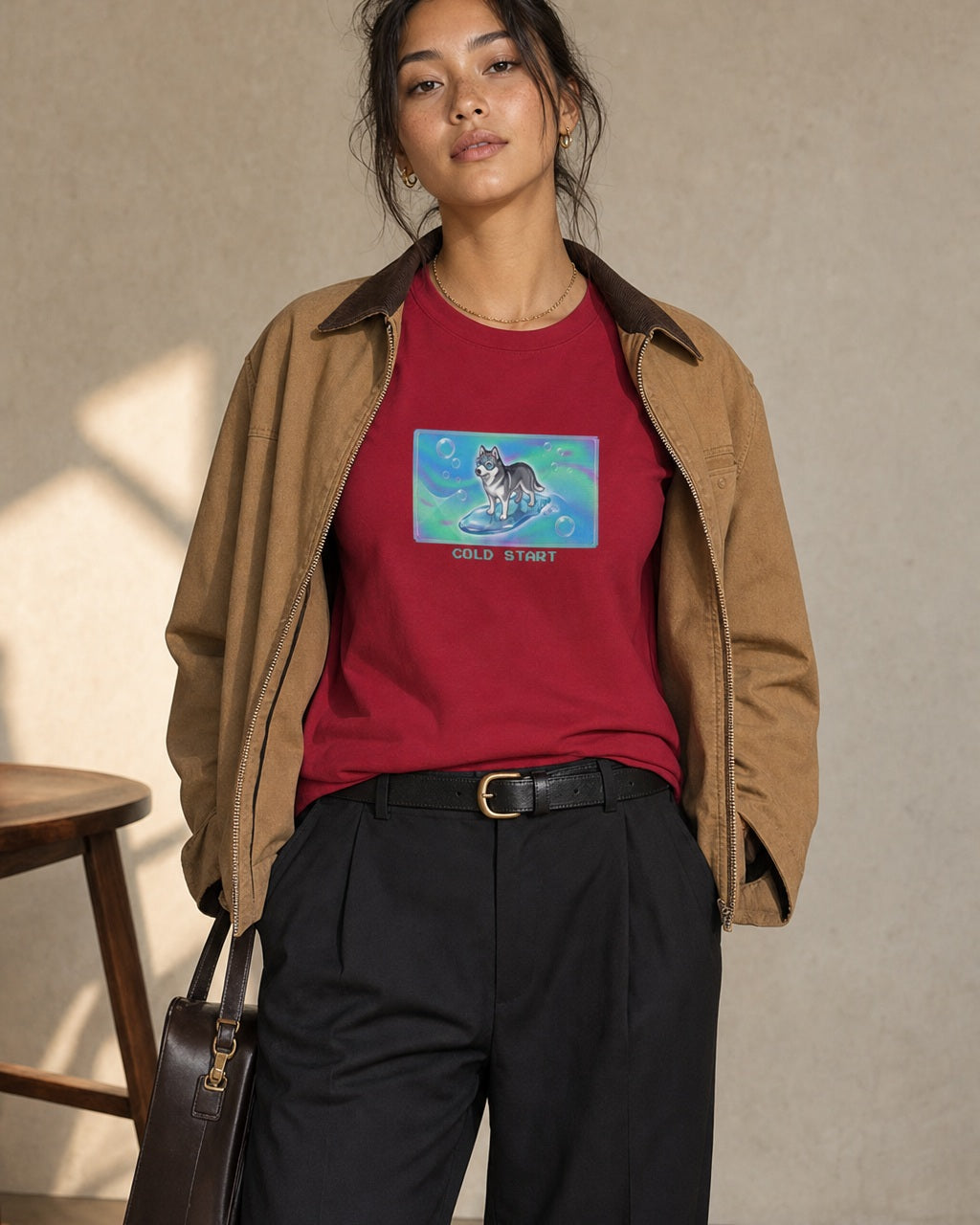 O's Tees Cold Start Husky Frutiger Aero Dogs graphic tee lifestyle image — Cardinal Red shirt, female shot 02, black trouser camel jacket