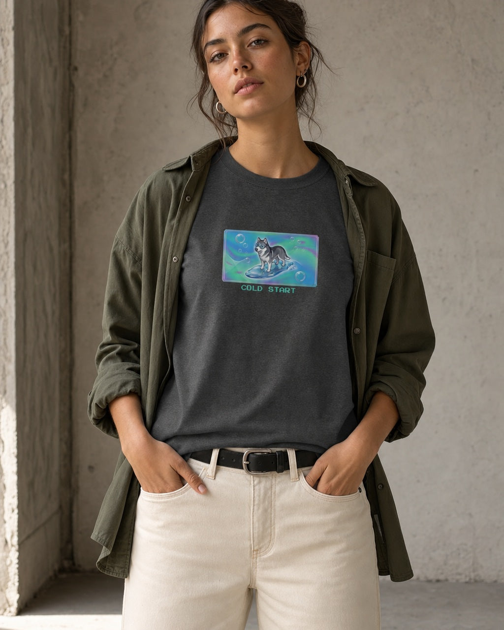 O's Tees Cold Start Husky Frutiger Aero Dogs graphic tee lifestyle image — Dark Heather shirt, female shot 01, ecru denim olive overshirt