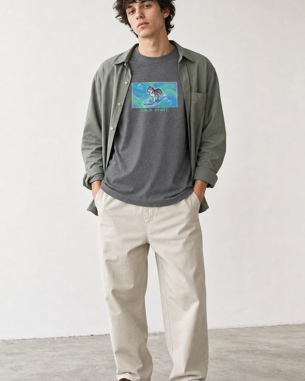 O's Tees Cold Start Husky Frutiger Aero Dogs graphic tee lifestyle image — Graphite Heather shirt, male shot 01, stone trouser sage overshirt