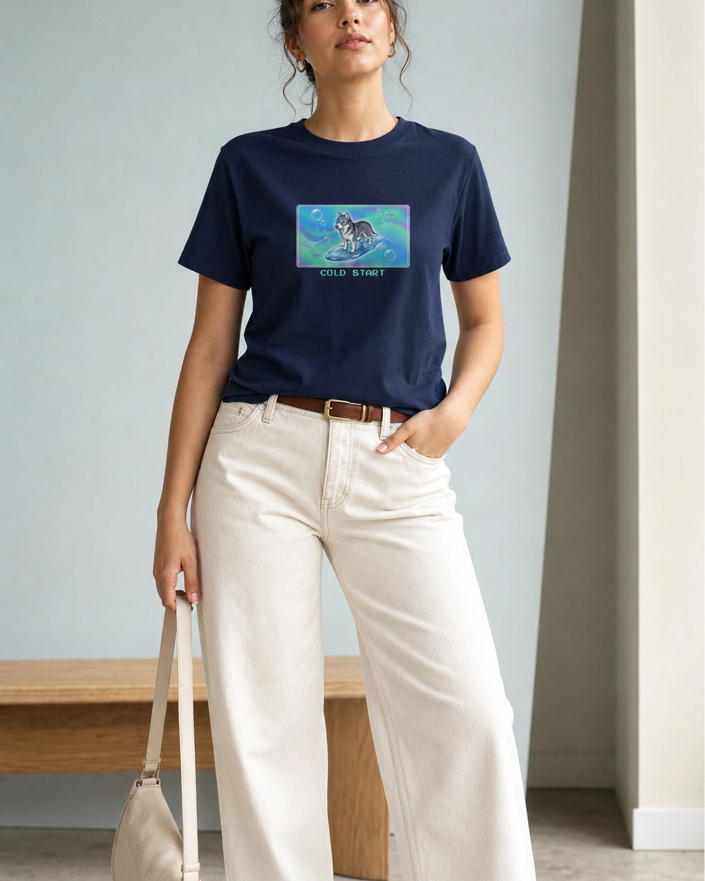 O's Tees Cold Start Husky Frutiger Aero Dogs graphic tee lifestyle image — Navy shirt, female shot 01, ecru barrel tan suede